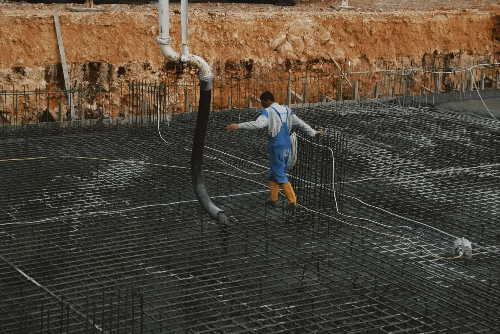 Steel reinforcement grid tied inside a pool excavation before gunite is applied